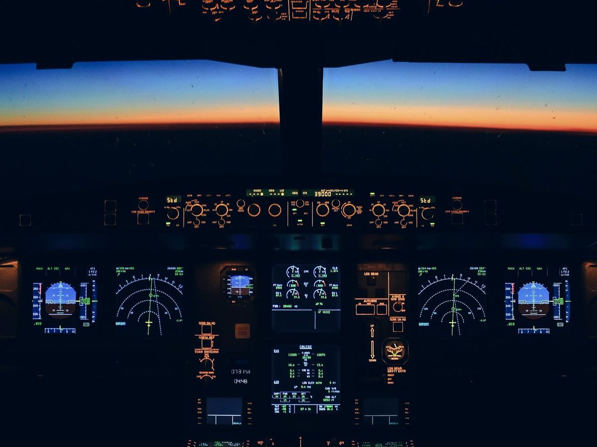 An airliner cockpit at dawn