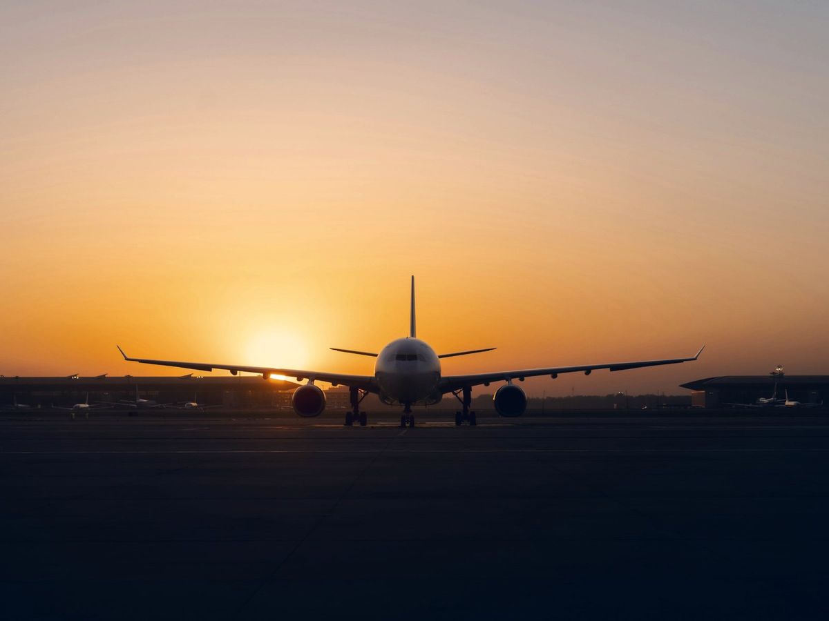 A plane on the stand as the sun comes up