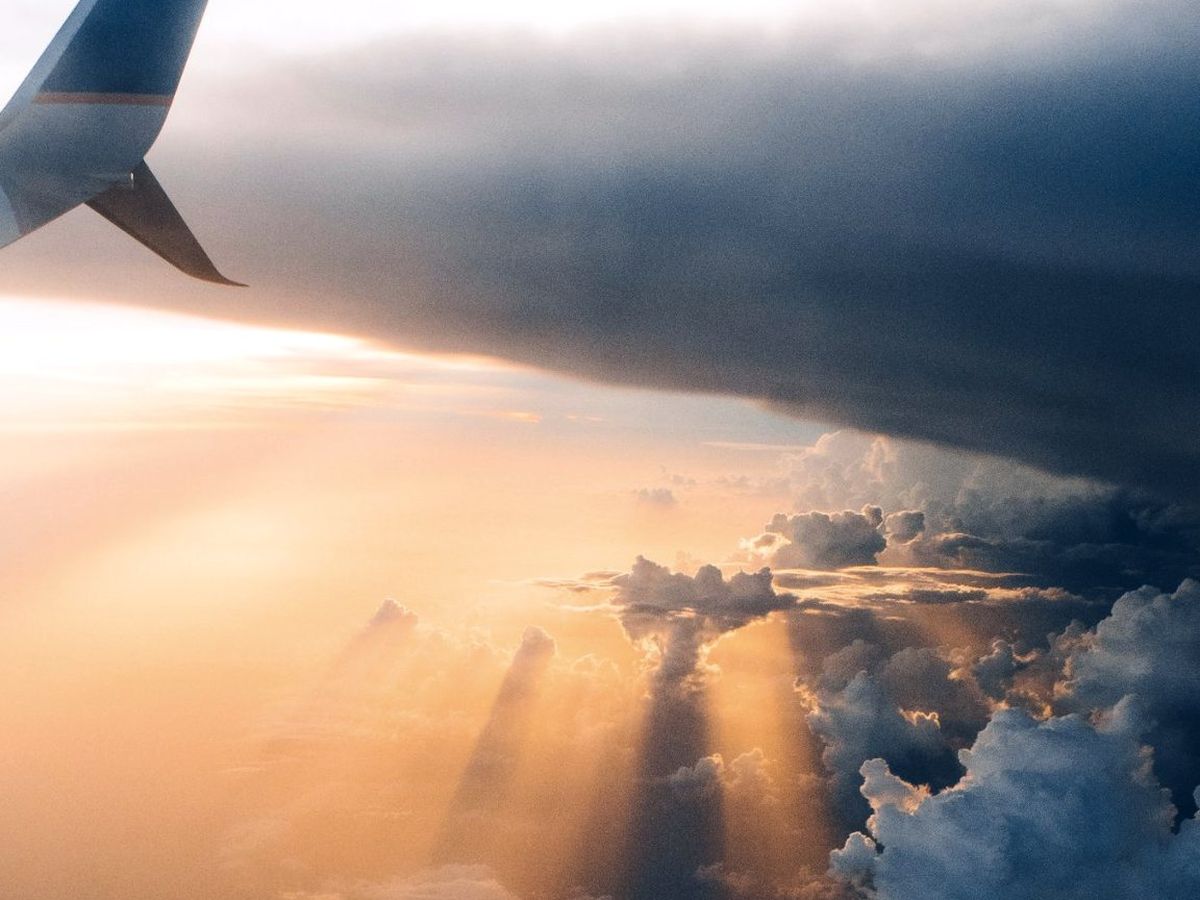 An aircraft wing above the clouds
