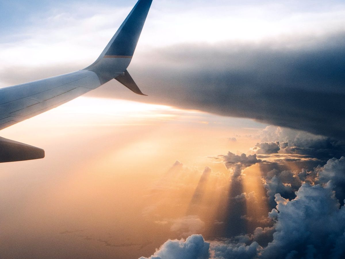 An aircraft wing above the clouds